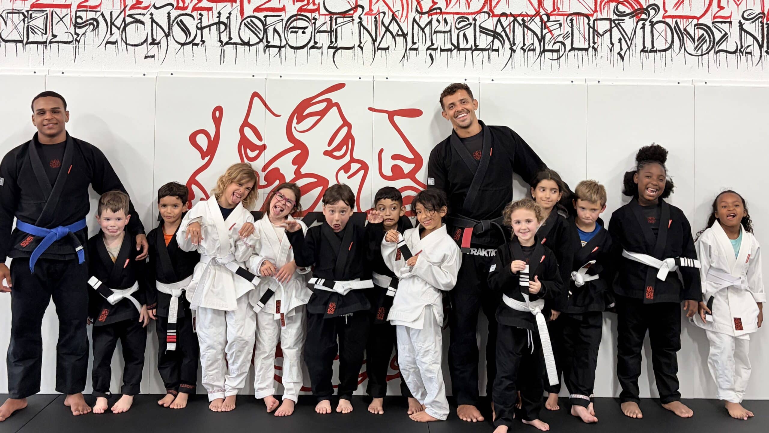 Kids training Brazilian Jiu Jitsu on the mat at Traktion Academy in Stuart, Florida