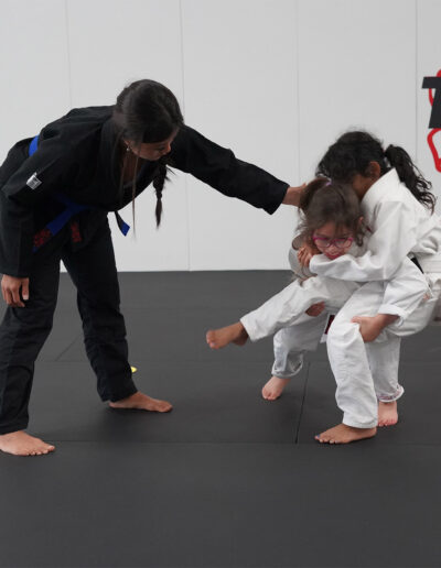 Coach Chloe teaching a kids class at Traktion Jiu Jitsu Academy